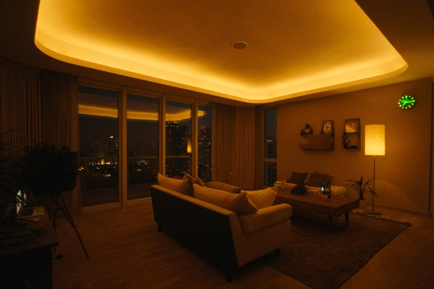 Living room after sunset, warm cove lighting along the ceiling